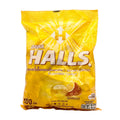 Yellow package of Halls cough drops on a white background