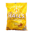 Yellow package of Halls cough drops on a white background