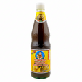 Bottle of mushroom vegetarian sauce with a yellow label on a white background