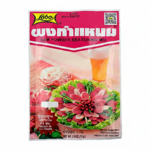 Lobo nam powder seasoning mix packaging with a floral arrangement and beer glass on a pink background
