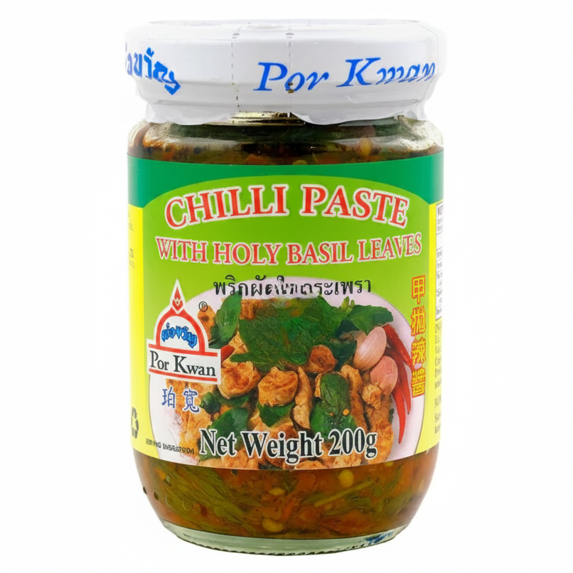 Jar of Por Kwan Chilli Paste with Holy Basil Leaves on a white background