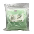 Green massage balm in a clear plastic bag with a label on a white background