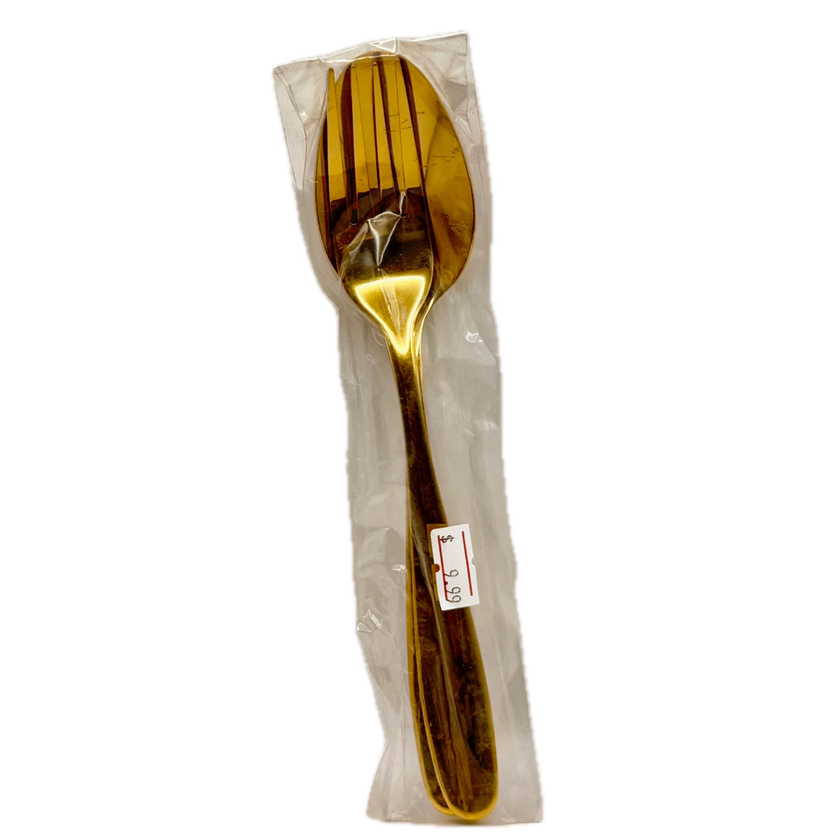 Gold stainless steel serving fork and spoon set in plastic packaging on white background