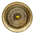 Gold Thai brass plate with intricate engraved traditional patterns on white background