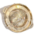 Round gold brass Thai offering tray with woven pattern interior in clear plastic packaging with price tag