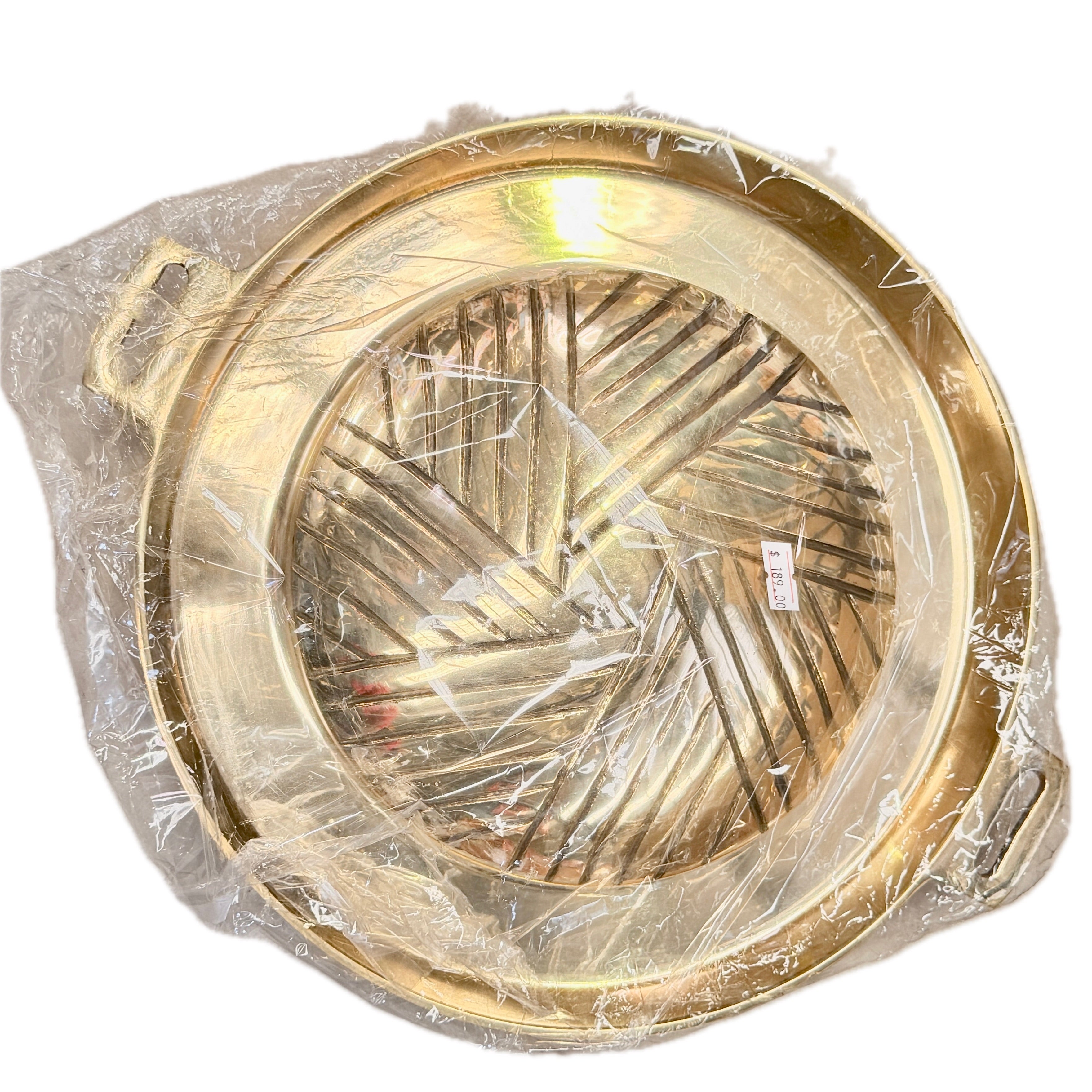 Round gold brass Thai offering tray with woven pattern interior in clear plastic packaging with price tag